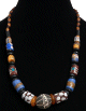 Collier ethnique artisanal imitation pierres cylindrees agrementees d'une boule gravee et de perles en bois