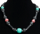 Collier ethnique artisanal imitation pierres multicolores agencees de perles argentees de et tubes noirs