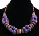 Collier ethnique artisanal imitation pierres multiformes et multicolores agrementees de perles multicolores