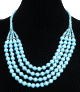 Collier ethnique artisanal quatre rangs imitation perles bleues claires agrementees de perles argentees