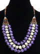 Collier ethnique artisanal trois rangs imitation pierres blanches et mauves agrementees de perles et de pieces argentees