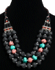 Collier ethnique artisanal imitation pierres multicolores, tubes noires et perles agencees de pieces argentees ciselees